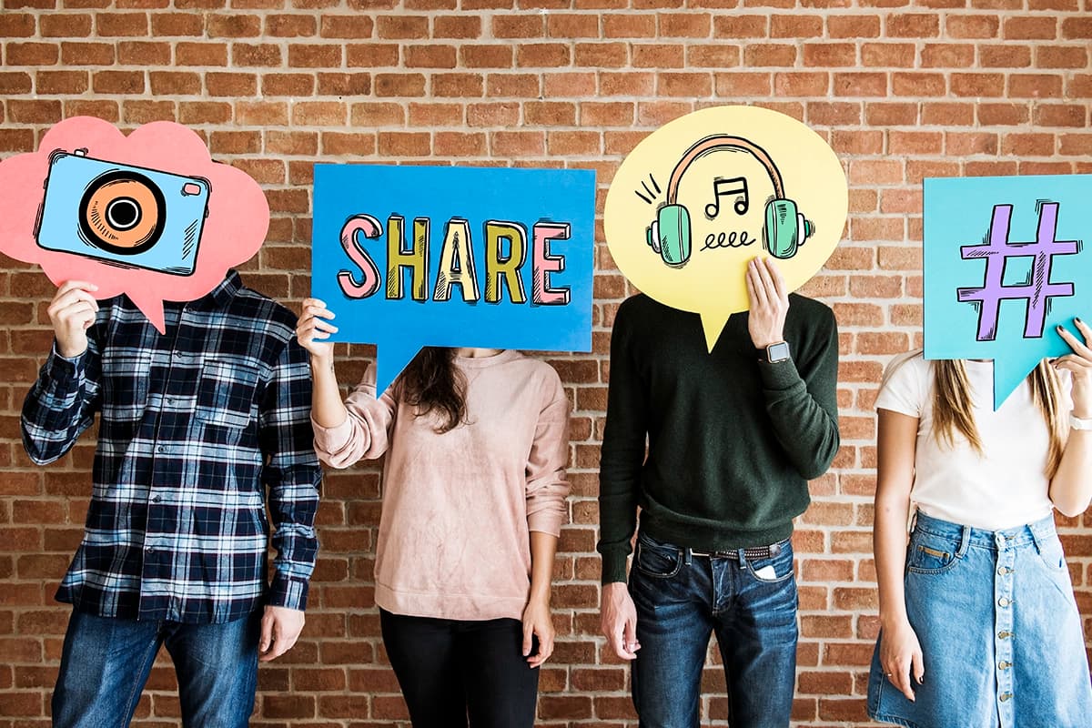 Friends holding up thought bubbles with social media