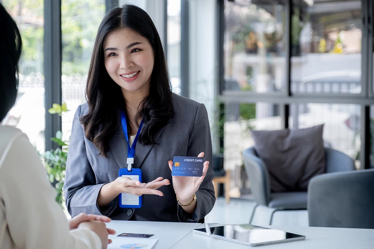 Financial services industry woman presenting credit card